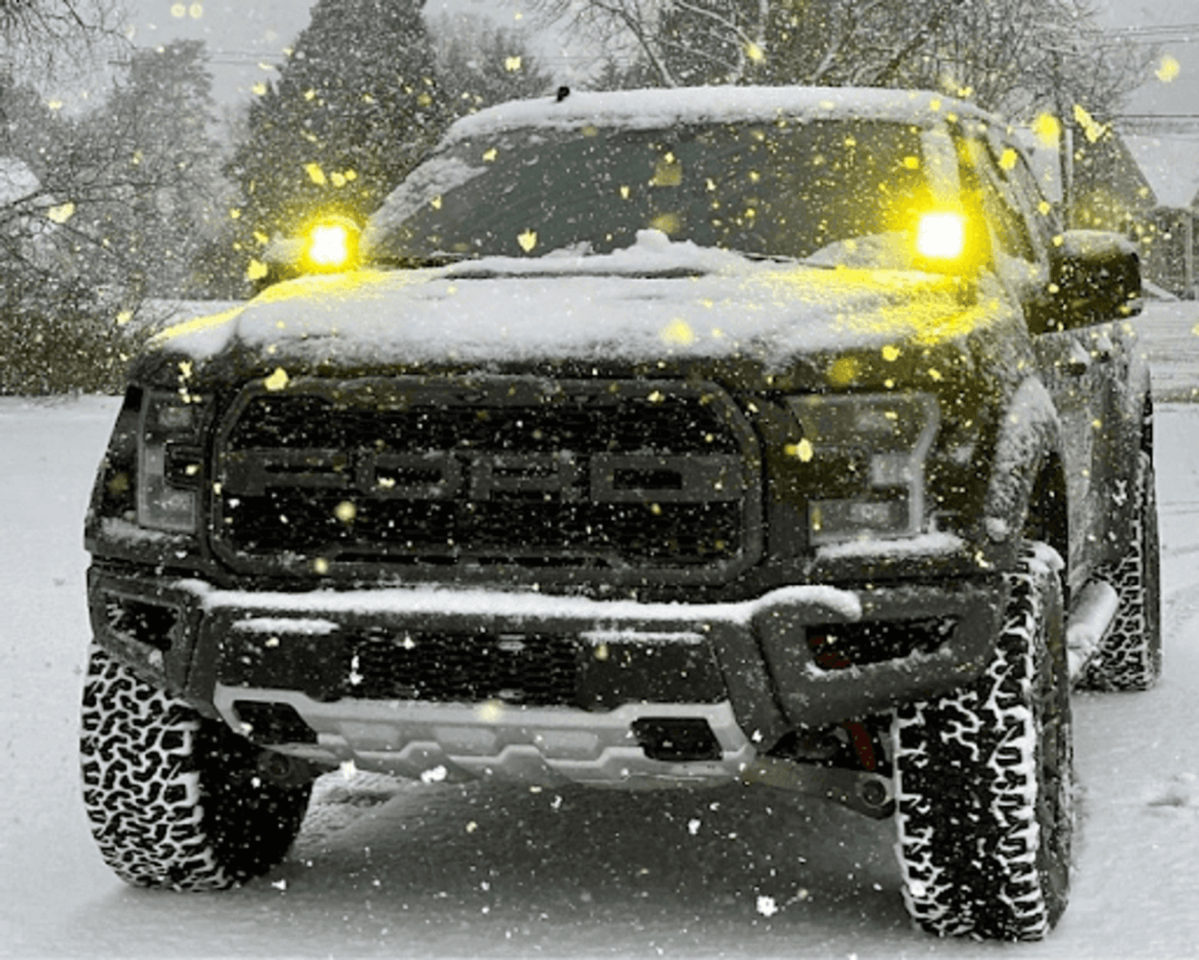 Car with fog lights on, driving through a snowy landscape, showing how fog lights improve visibility.