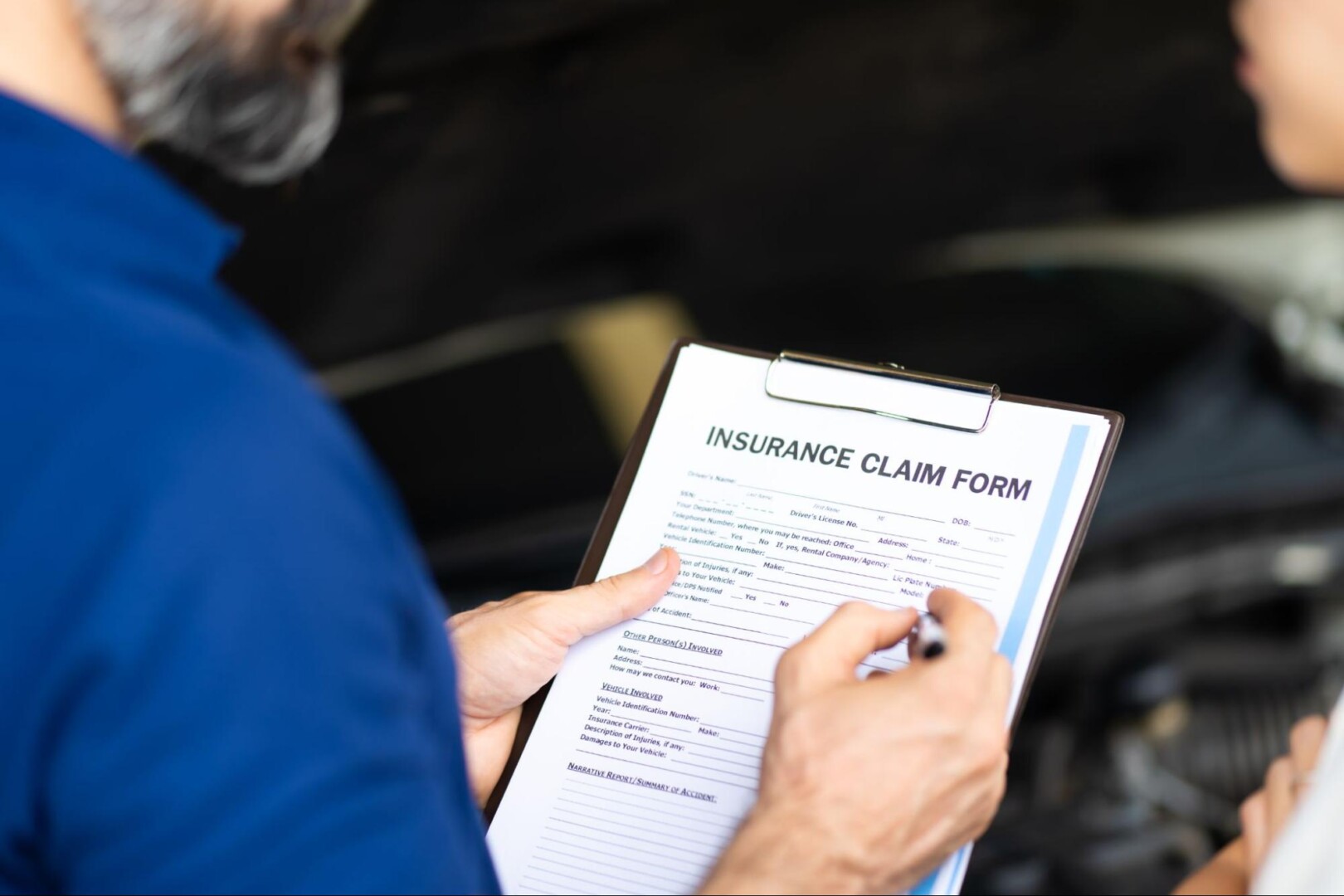 Person reviewing their car insurance policy to ensure proper coverage.