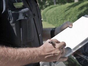 Texas officer writing a ticket on a clipboard.